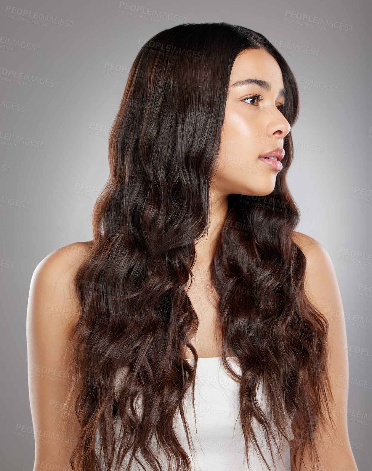 Buy stock photo Woman with hair, beauty with balayage and curly hairstyle with haircare and keratin treatment on studio background. Female person with shine and texture, growth and grooming with glamour and glossy