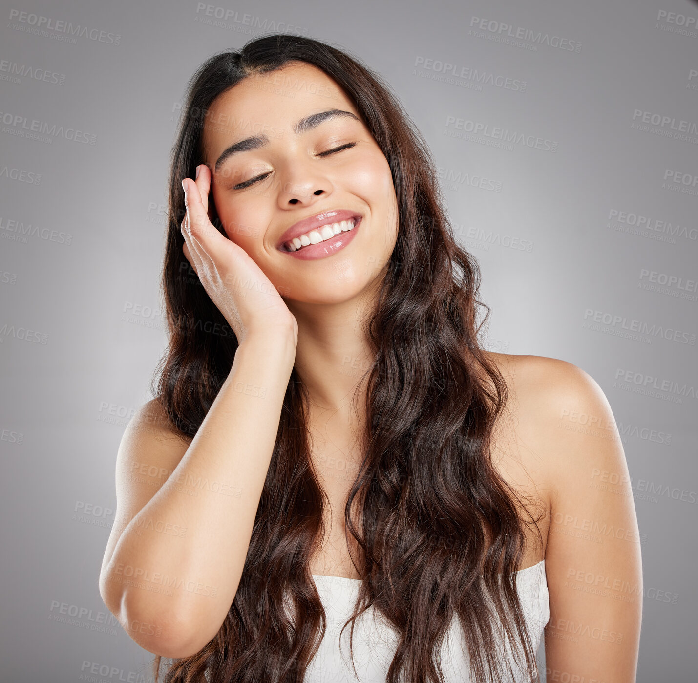 Buy stock photo Studio shot of an attractive young woman posing against a grey background