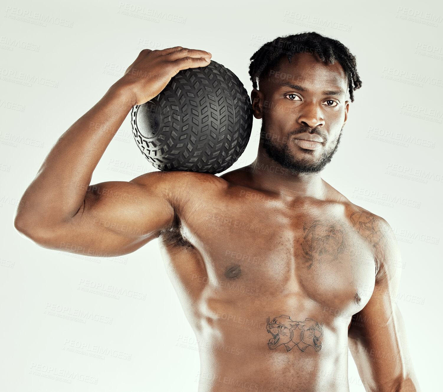 Buy stock photo Studio shot of an athletic young man posing with a medicine ball
