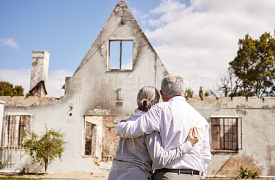 Buy stock photo Shot of a senior couple comforting each other after losing their home to a fire