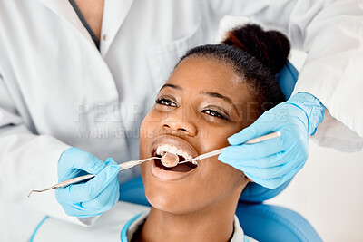 Buy stock photo Shot of a young female patient having her teeth examined