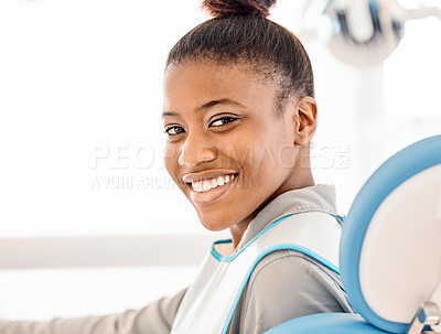 Buy stock photo Shot of a young woman awaiting treatment at a dentists office