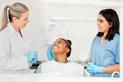 Buy stock photo Shot of a dentist and her nurse treating a patient