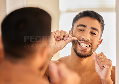 Buy stock photo Man flossing in mirror, teeth whitening and dental with mouth cleaning product, hygiene and daily morning routine at home. Male person with smile, floss in bathroom for oral health and grooming