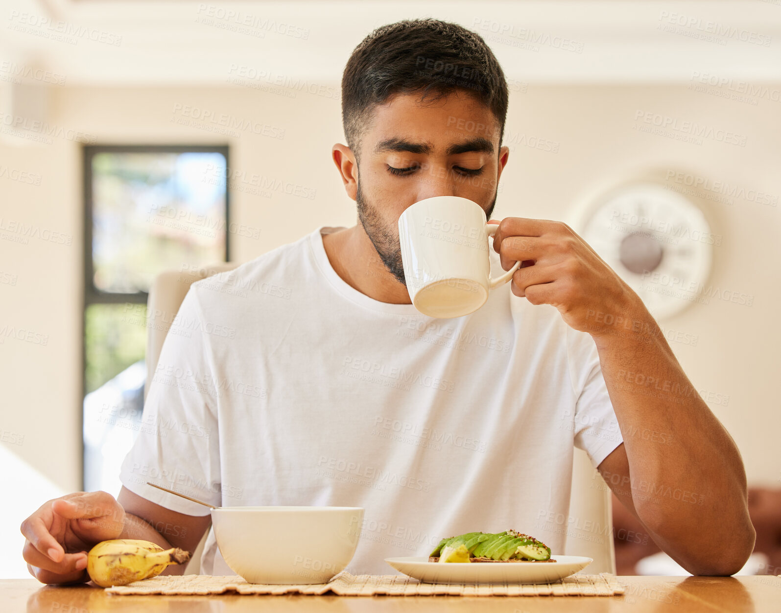 Buy stock photo Morning, coffee and breakfast with man at table for wake up, nutrition and food. Relax, wellness and detox diet with male person eating healthy meal at home for hungry, weekend and energy
