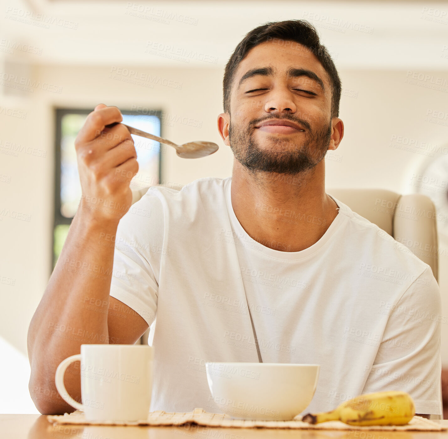 Buy stock photo Morning, happy and breakfast with man at table for wake up, nutrition and food. Relax, wellness and detox diet with male person eating muesli cereal at home for health, weekend and energy