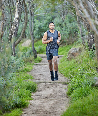 Buy stock photo Man is run in forest, fitness and cardio in nature with exercise and healthy, active lifestyle. Male runner on running path, train for marathon with speed, energy and workout for health and sport