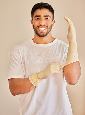 Buy stock photo Cleaning, gloves and portrait of man with smile for work, service and maintenance on white background. Indian person, pride and happy with hygiene accessory for hospitality job, health and safety