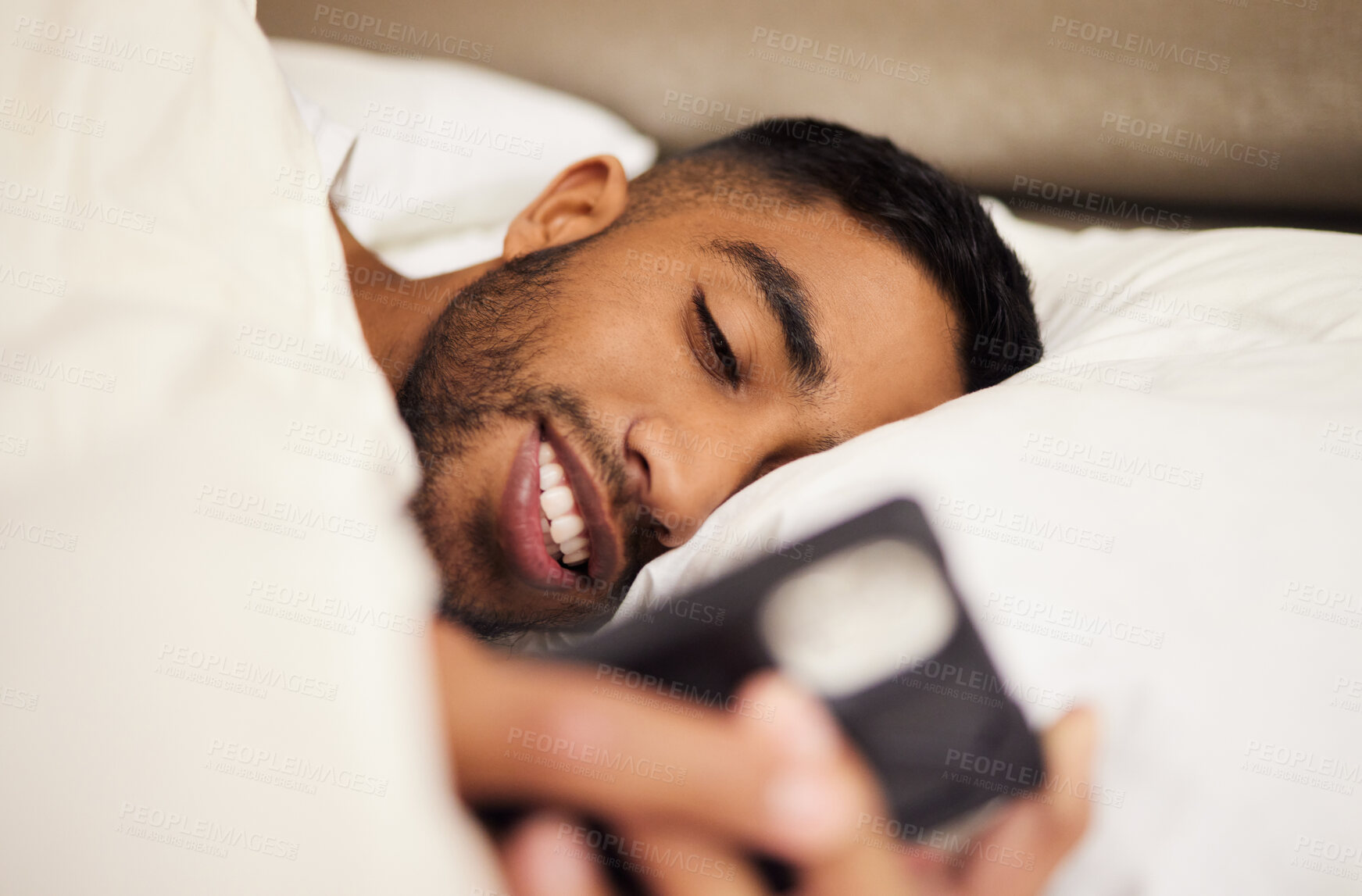 Buy stock photo Man, bed and tired or phone for internet in home, pillow and network to scroll on social media. Male person, bedroom and reading on website, blanket and app for communication or chat in apartment