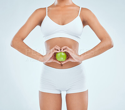 Buy stock photo Health, stomach and apple with diet for woman, digestion and nutrition on white background. Fruit, vegan and detox for weight loss and benefits, gut and colon wellness for vitamins and food in studio