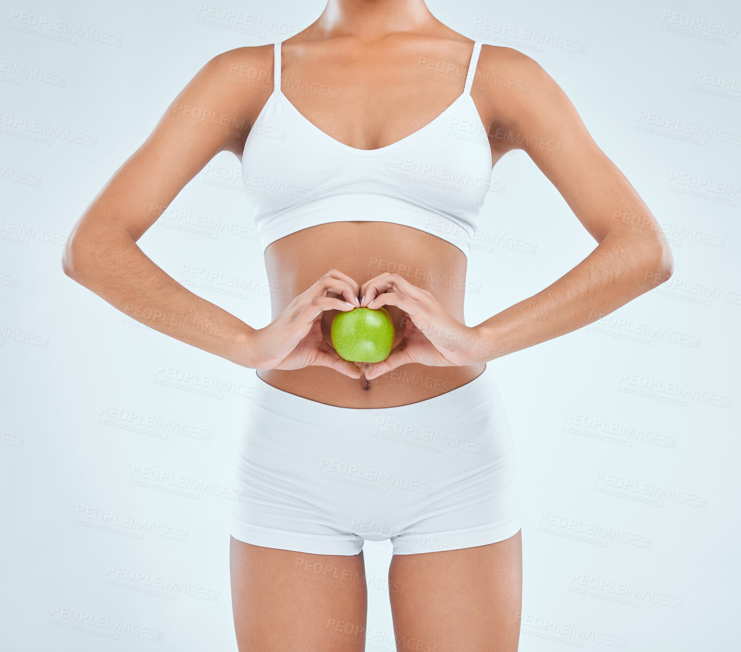 Buy stock photo Health, stomach and apple with diet for woman, digestion and nutrition on white background. Fruit, vegan and detox for weight loss and benefits, gut and colon wellness for vitamins and food in studio