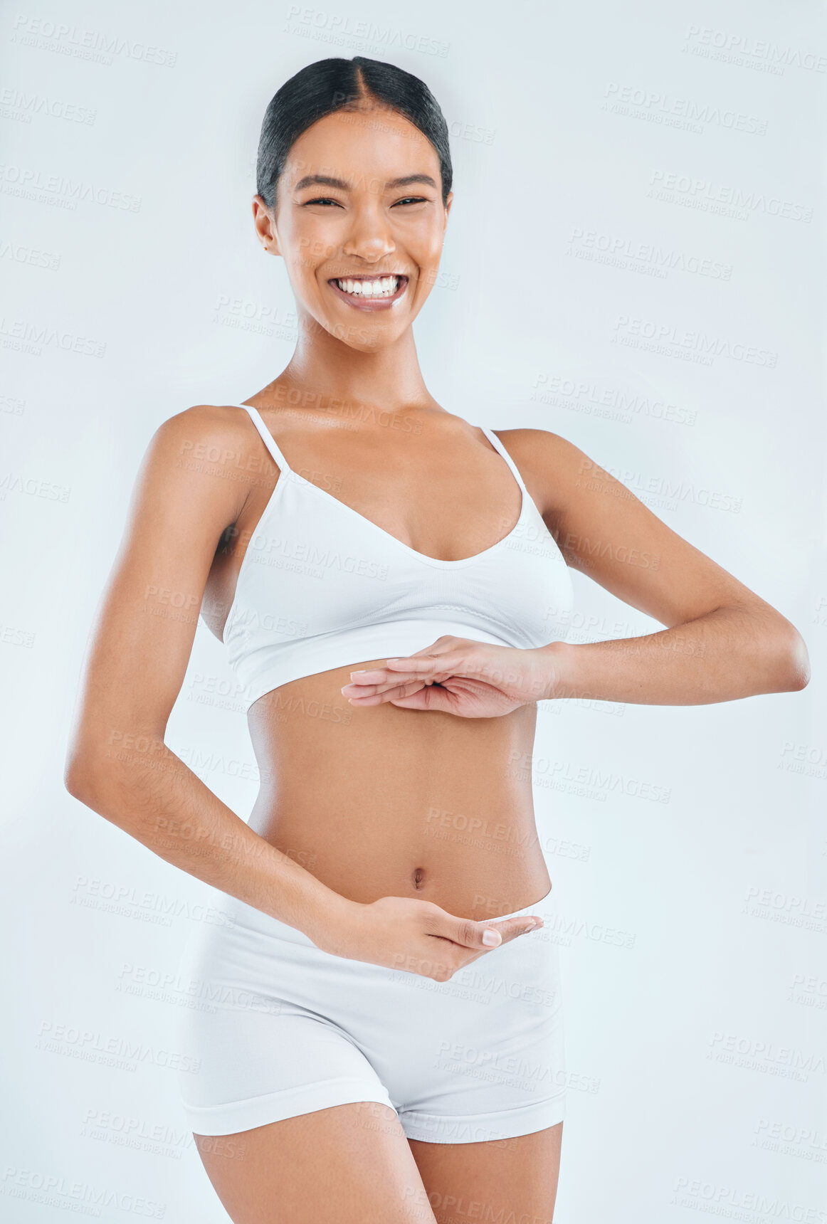 Buy stock photo Body, digestion and hands on stomach for woman in studio, nutrition and gut health on white background. Wellness, healthy goals and portrait of female model, diet and balance fitness lifestyle 