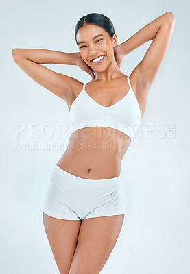 Buy stock photo Portrait, health and woman in underwear studio, stomach and nutrition on white background. Smile, wellness and fitness training with diet for weight loss, active body and gut balance with arms up