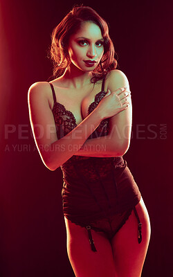 Buy stock photo Cropped portrait of a beautiful young woman posing in lingerie against a red background