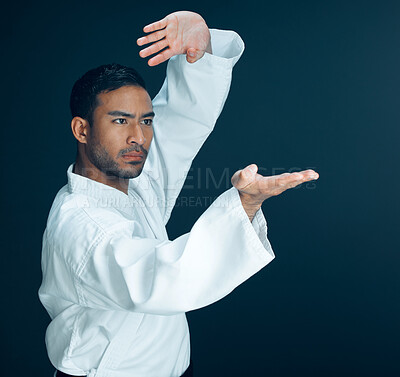 Buy stock photo Karate, training and man in martial arts on studio, black background and practice exercise. Serious, fight and person with skill in self defence technique, action or fighter gesture with hands