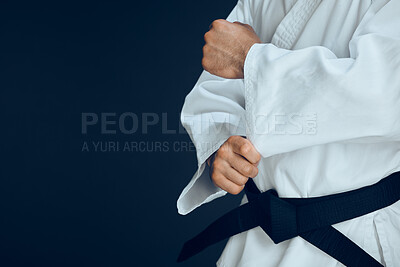 Buy stock photo Man, hands and ready for karate in studio, fighter and start for training or practice on dark background. Male person, athlete and warrior in dojo for martial arts, mockup space and sports technique