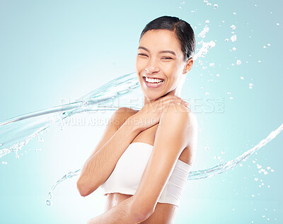 Buy stock photo Shot of a beautiful young woman being splashed with water against a studio background