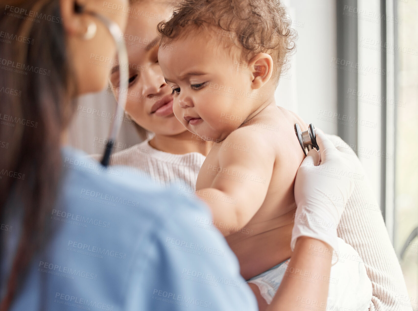 Buy stock photo Shot of a doctor listening to a baby's chest with her stethoscope