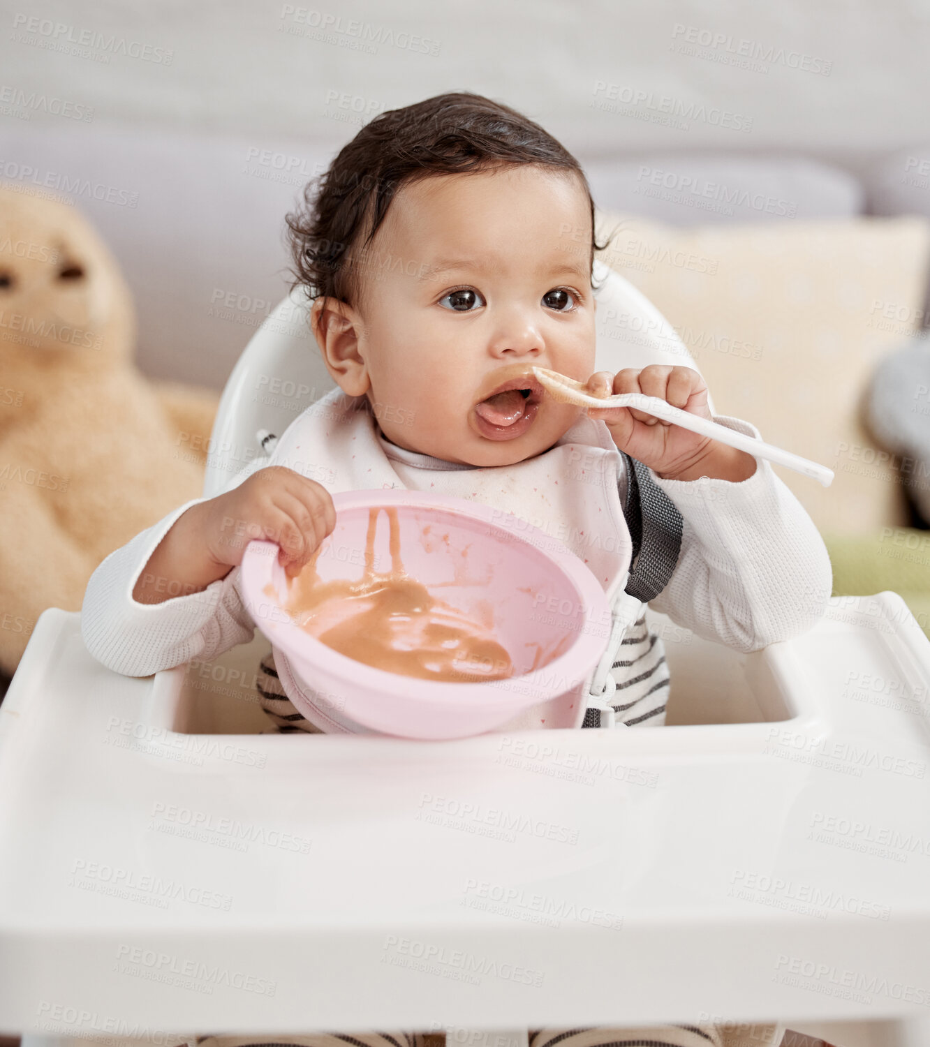 Buy stock photo Shot of a baby eating a meal at home