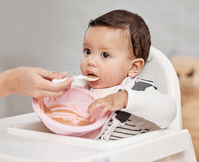 Buy stock photo Shot of a baby being fed at home