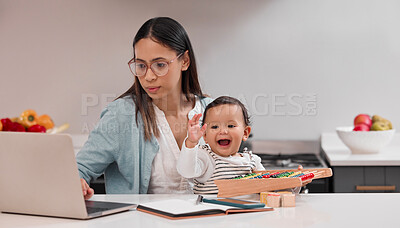 Buy stock photo Shot of a young mother working from home while holding her baby