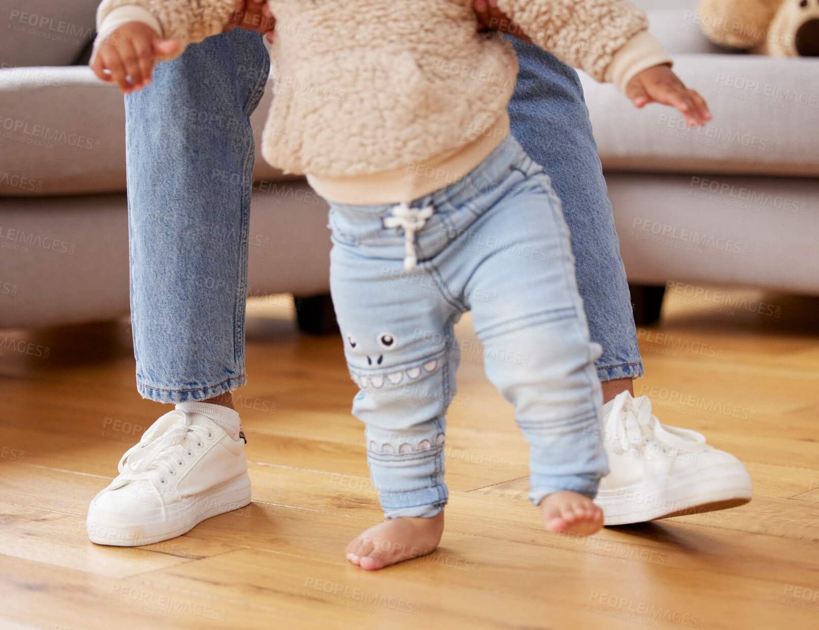 Buy stock photo Feet, child and learning to walk with parent, growth and development in lounge, morning and family. Floor, house and living room of mom with baby, progress and together with love, care and trust