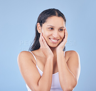 Buy stock photo Shot of a beautiful young woman posing against a blue background