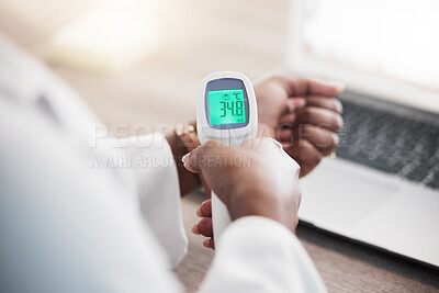 Buy stock photo Shot of an unrecognisable doctor checking her temperature with a thermometer