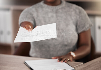 Buy stock photo Shot of an unrecognisable businesswoman handing a document at her desk in a modern office