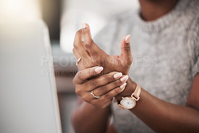 Buy stock photo Shot of a businesswoman experiencing wrist pain while using a laptop in a modern office