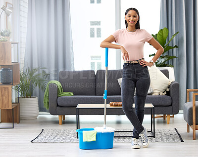 Buy stock photo Full length portrait of an attractive young woman posing with a mop while cleaning her home