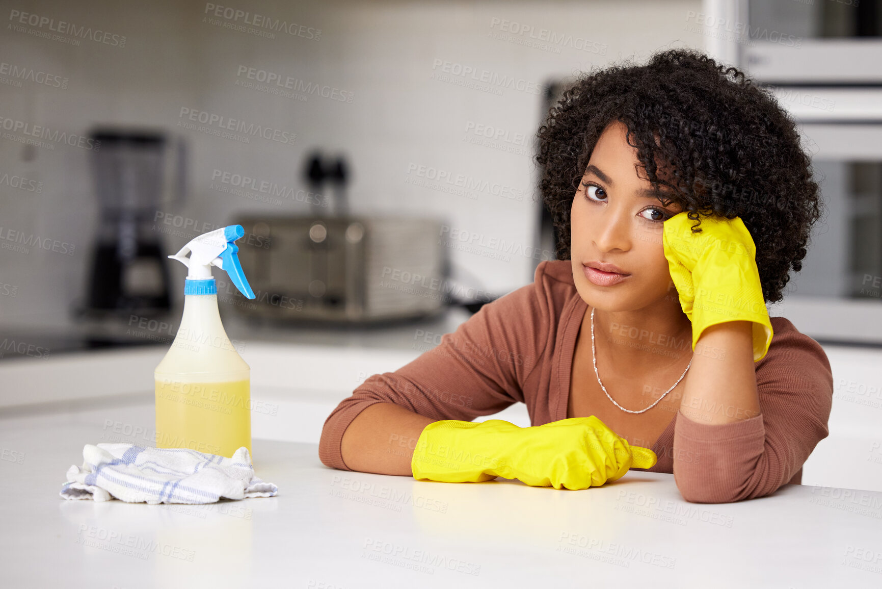 Buy stock photo Bored, cleaning and portrait of black woman in kitchen of home for housekeeping chores. Cloth, gloves and spray with exhausted or tired person at counter in apartment for housework or responsibility