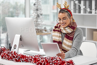 Buy stock photo Shot of a young woman in the festive period working in a office
