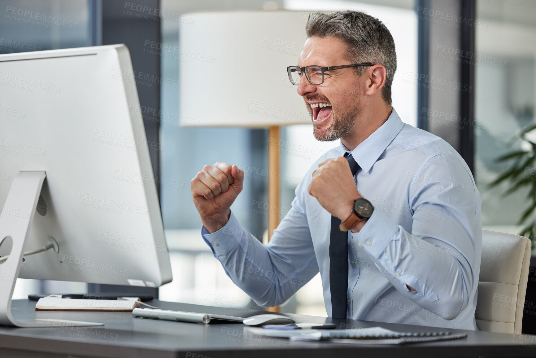 Buy stock photo Happy, businessman and fist in celebration for promotion, winning or success by desk at the office. Man employee in joy for win, achievement or bonus on computer in sale, target or prize at workplace