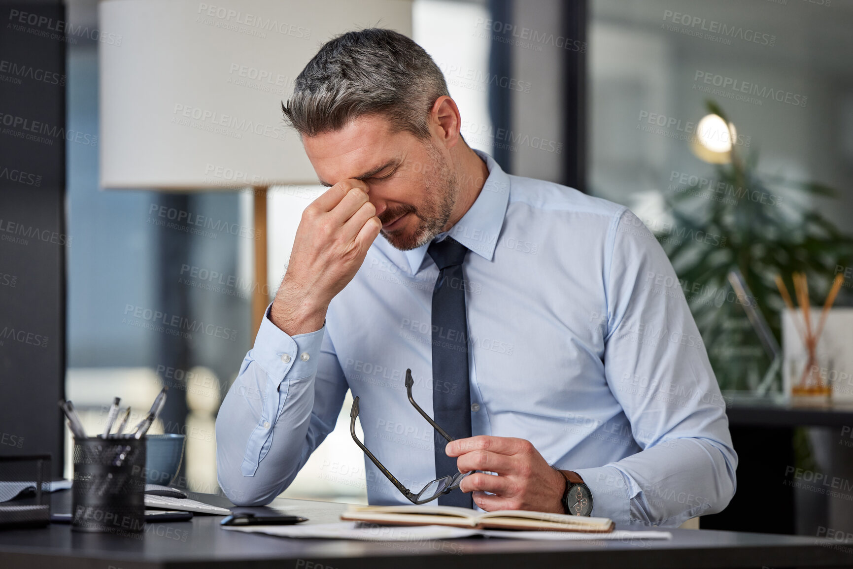 Buy stock photo Anxiety, headache or stress with business man at desk in office for audit, compliance or tax. Burnout, depression and mental health with mature employee in pain at corporate or professional workplace