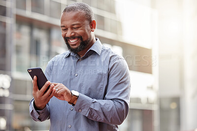 Buy stock photo Phone, text message a senior business black man in the city, typing an email while commuting to work. Mobile, contact and social media with a happy mature male employee networking in an urban town