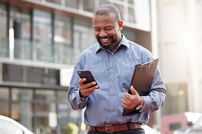 Buy stock photo Businessman, phone and typing an email at office, building and corporate workplace communication. Happy, senior and black man on mobile, smartphone or technology for online search, text or contact
