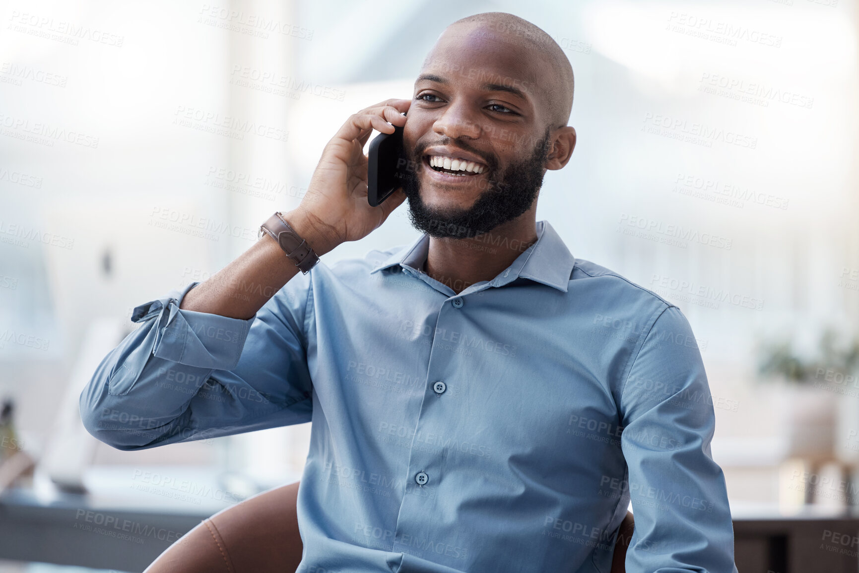 Buy stock photo Cropped shot of a handsome young businessman making a call while sitting in his office