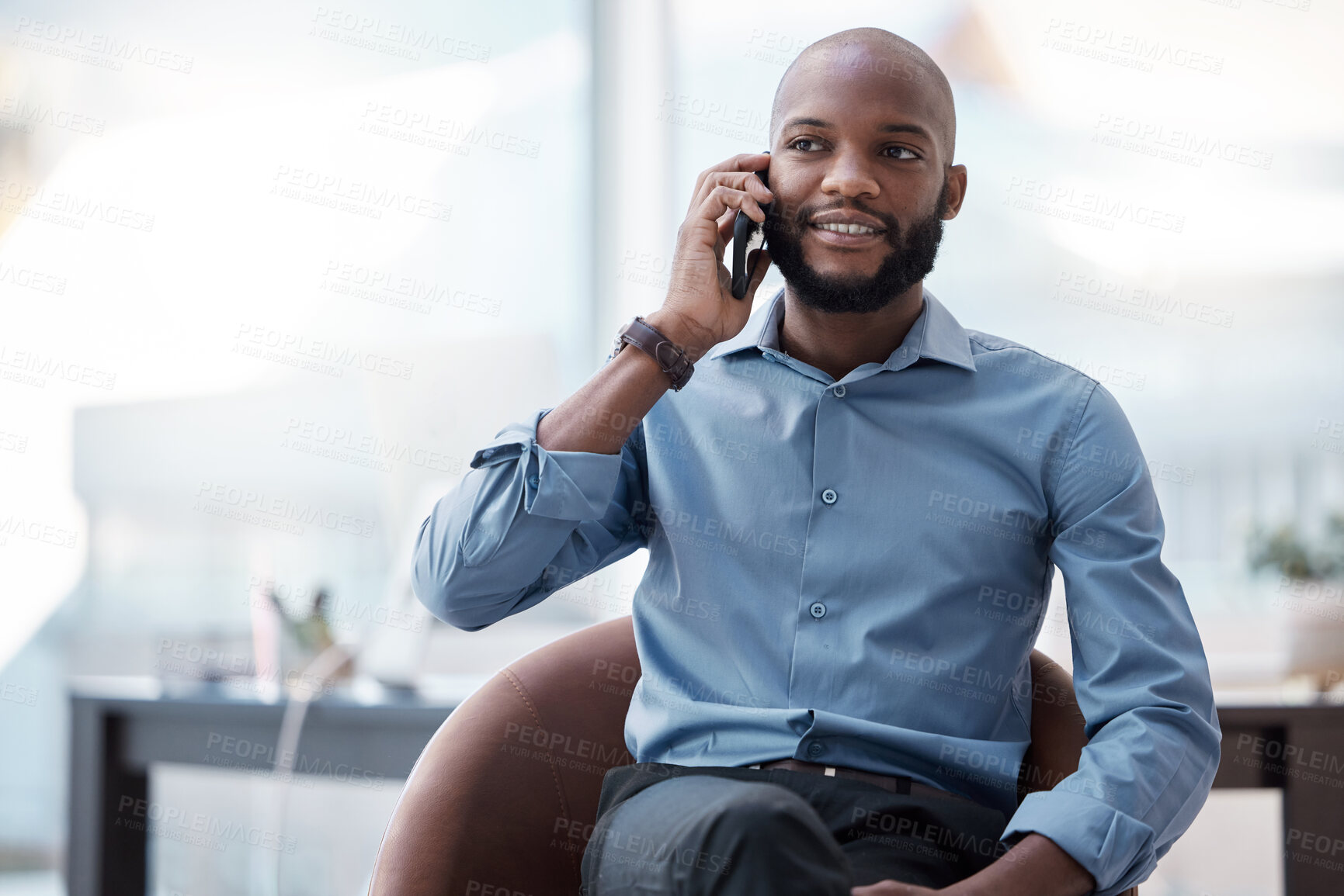 Buy stock photo Black man, phone call and talking in office, networking and negotiation on deal for company. Male person, armchair and feedback on planning or proposal, consulting and communication on app to speak