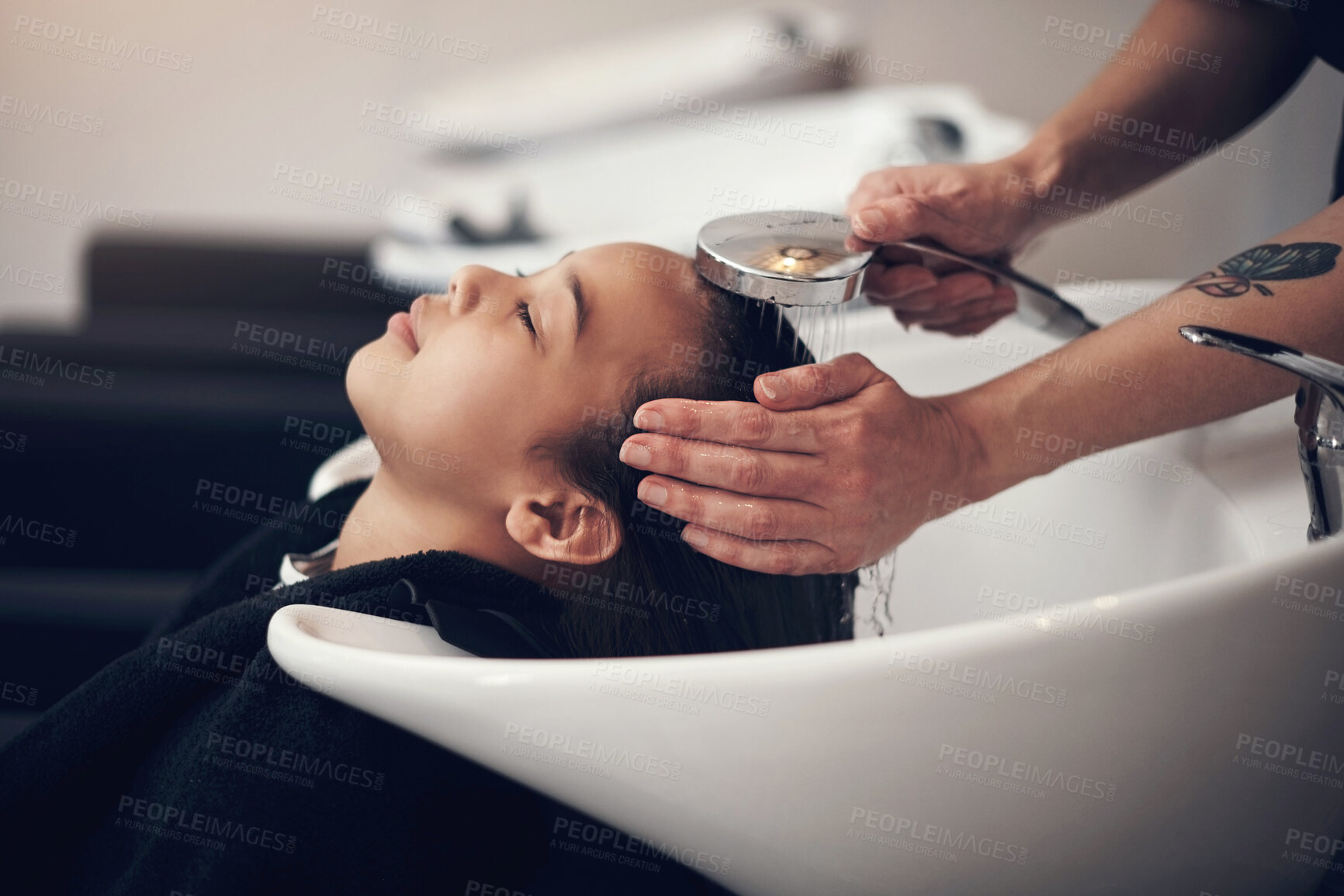 Buy stock photo Washing hair, girl or hands of stylist in salon, spa or basin for scalp care or cleaning treatment. Rinse, relax or grooming service for customer or shampoo cosmetics for beauty, wellness or water