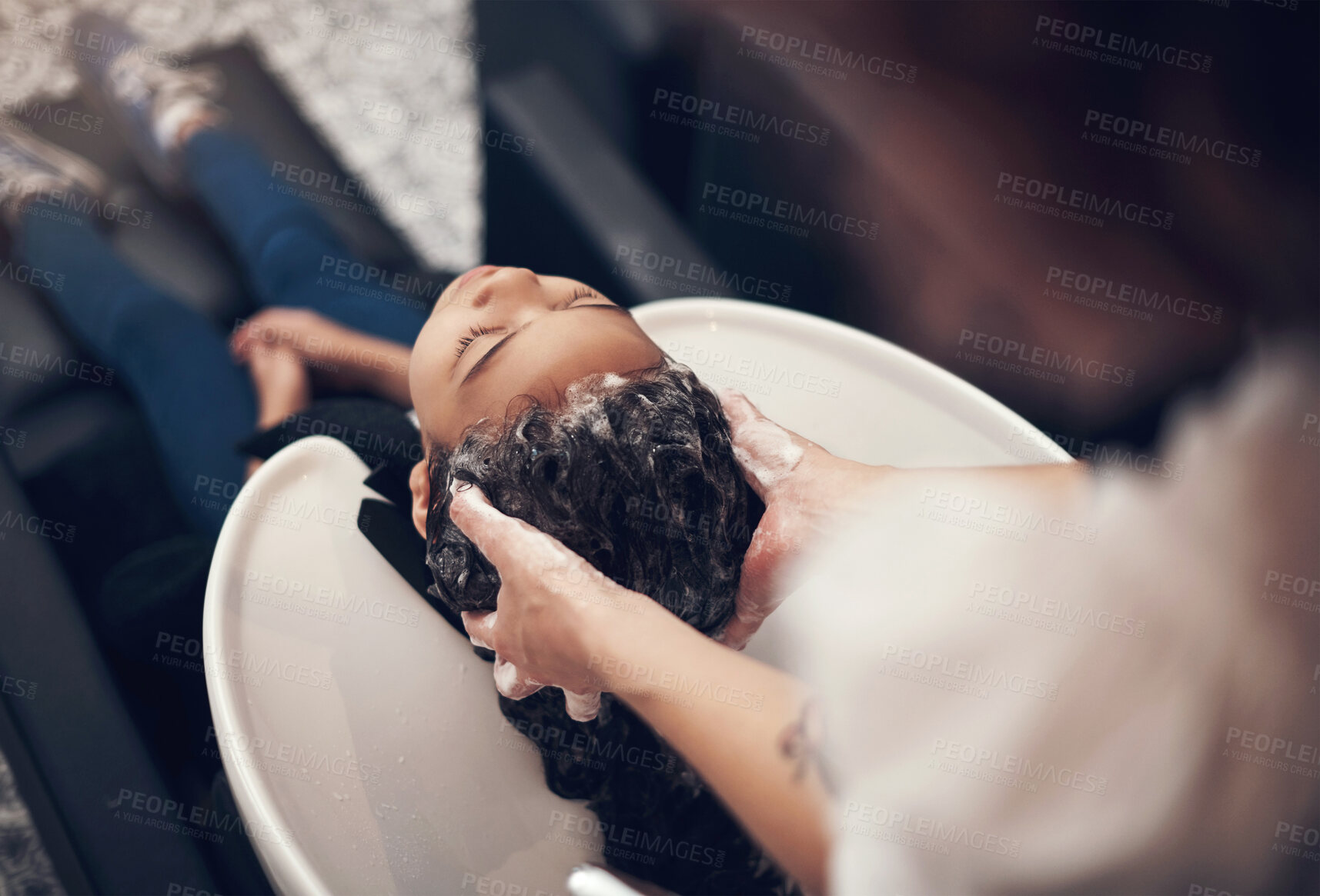 Buy stock photo Washing, girl child and hairdresser with hair care in salon for shampoo, treatment or conditioner. Above, beauty and client with hands of stylist for cleaning, luxury massage or service by basin