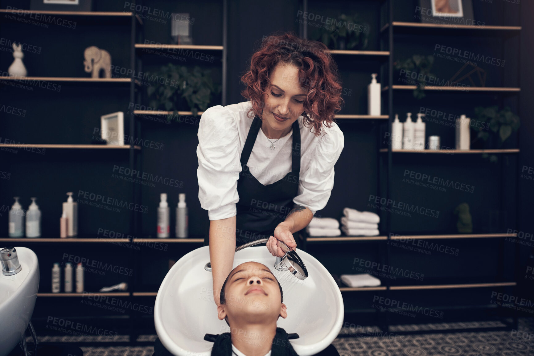 Buy stock photo Washing, child or hairdresser with client in salon or basin for scalp, care and cleaning treatment. Rinse, girl or grooming service for customer or shampoo cosmetics for beauty, wellness and spa 