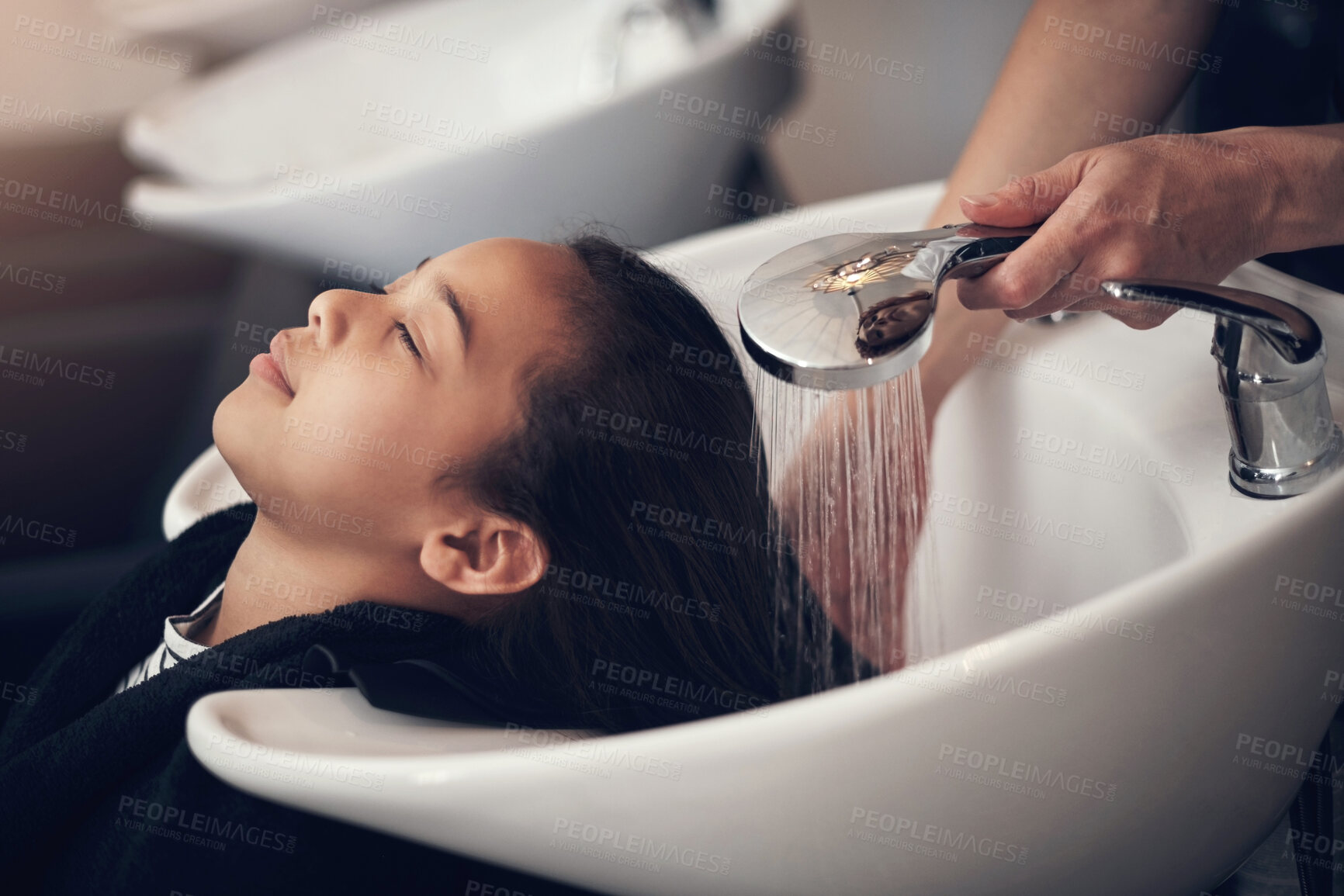 Buy stock photo Washing hair, women or hands of stylist in salon, spa or basin for scalp care or cleaning treatment. Rinse, relax or grooming service for customer or shampoo cosmetics for beauty, wellness or health