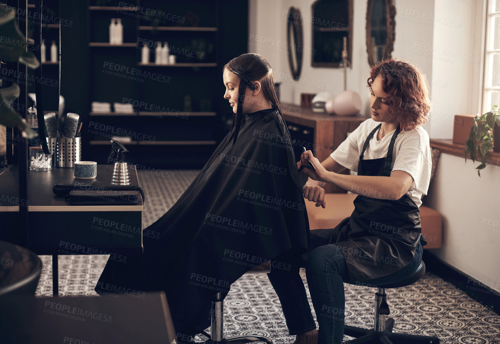 Buy stock photo Shot of a hairstylist cutting a client's hair in a salon