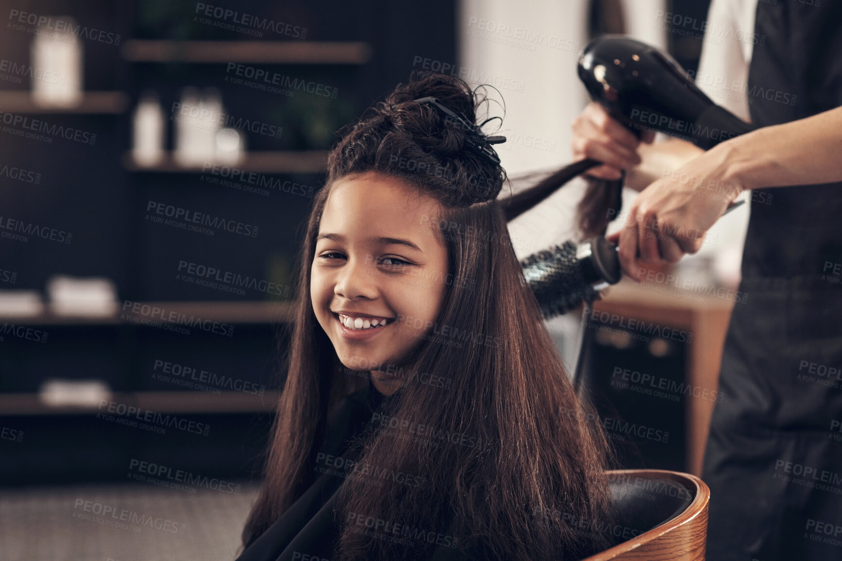 Buy stock photo Girl, client and portrait for hairdryer in hairdresser, small business and beauty industry with stylist for hair service. Customer, happy child for pamper grooming, brush and professional or people