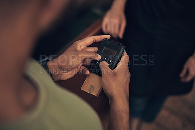 Buy stock photo Cropped shot of an unrecognisable man using a card machine to pay his hairdresser in the salon