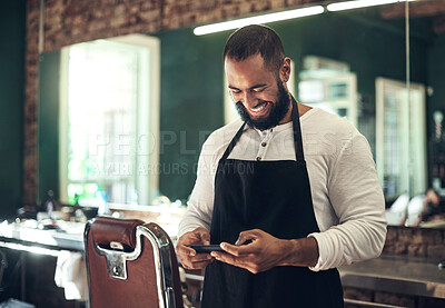 Buy stock photo Barber, happy and man with phone in salon for internet, social media and website for beauty service. Stylist, small business and hairdresser on smartphone for haircare, grooming and hairstyle