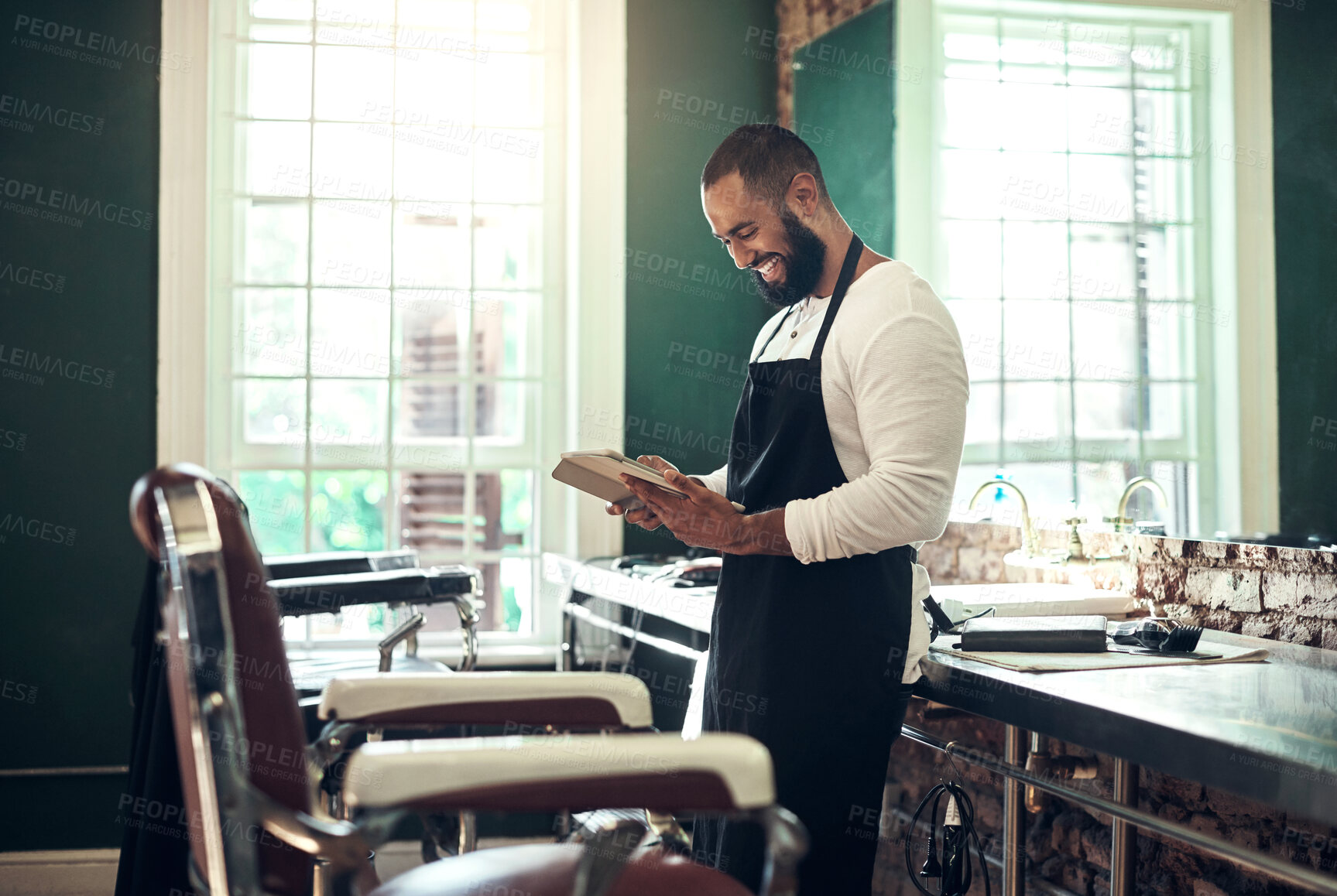 Buy stock photo Business, barber and man with smile for tablet in salon for schedule, online appointment and calendar check. Startup, owner and digital tech for haircare research, styling tips and happy for booking