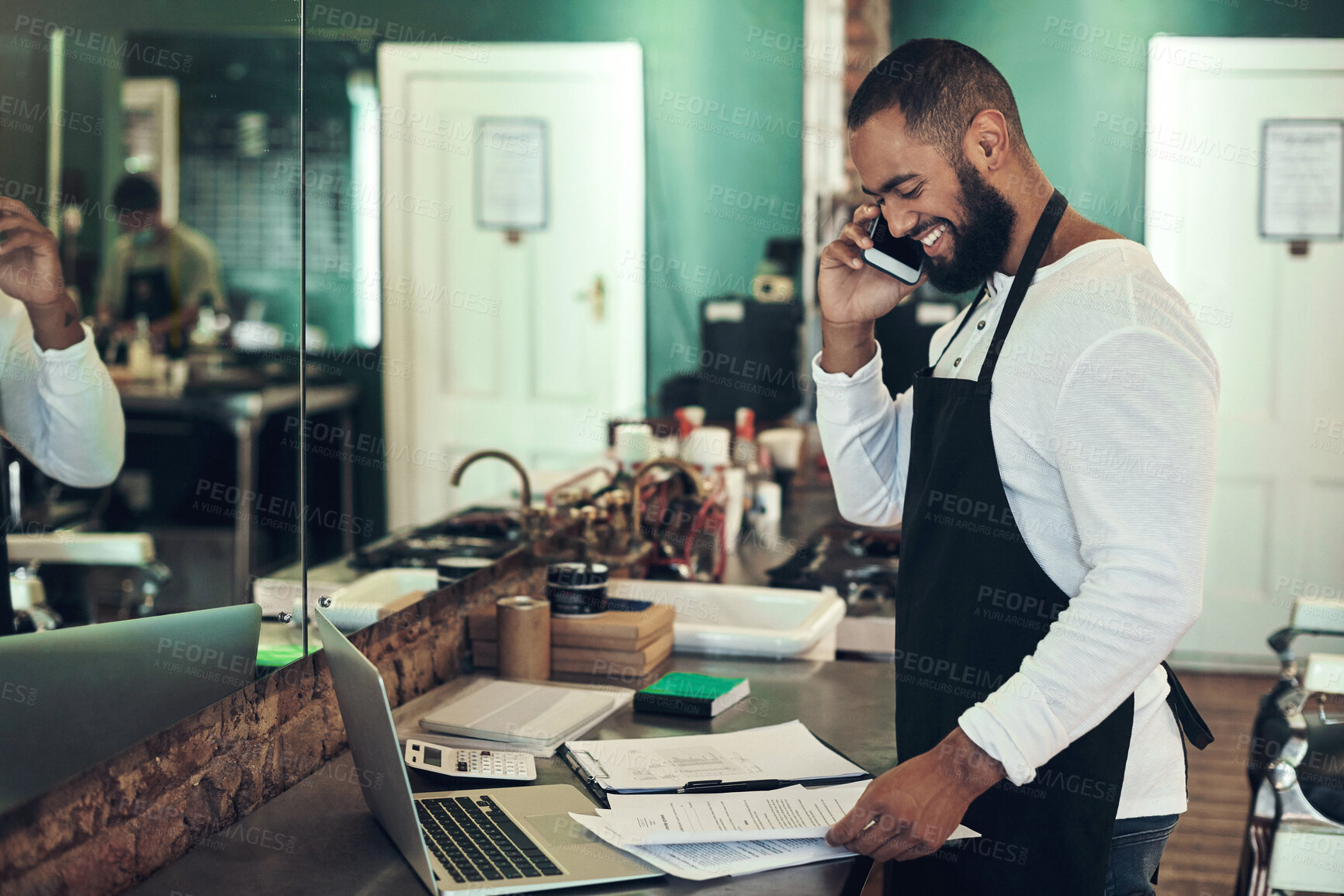 Buy stock photo Smile, paperwork and man with phone call at barber for client appointment, discussion and availability. Small business, stylist and person with tech at spa for booking, consulting or customer support