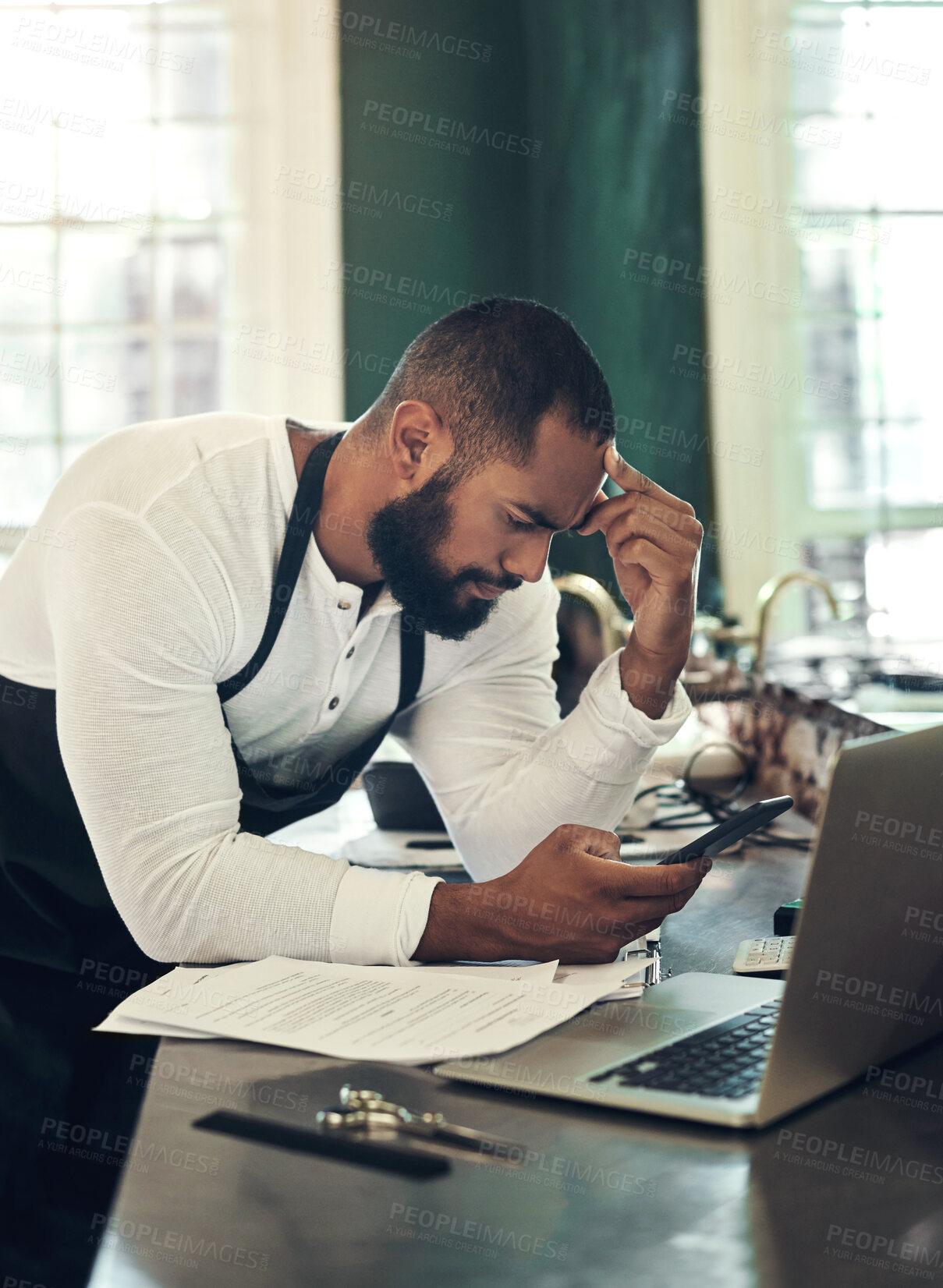 Buy stock photo Barber, stress and man with documents and phone for financial planning, budget and insurance. Hair salon, small business and frustrated hairdresser on computer with paperwork for tax, bills or debt